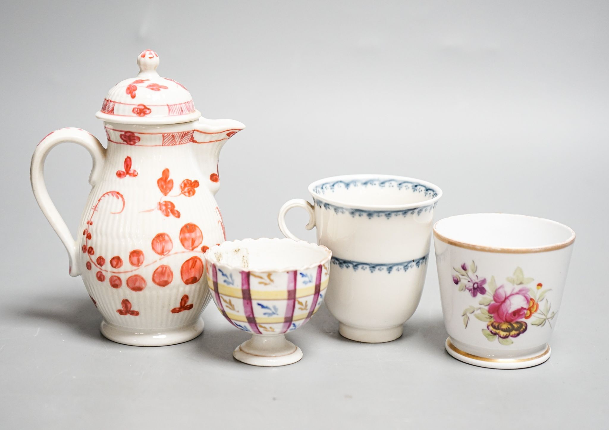 A Vienna chocolate cup, c.1760, a Tettau reeded covered jug c.1790, 13.5cm, a Volkstedt zarf cup for the Ottoman market c.1780 and a German porcelain coffee cup 14cm